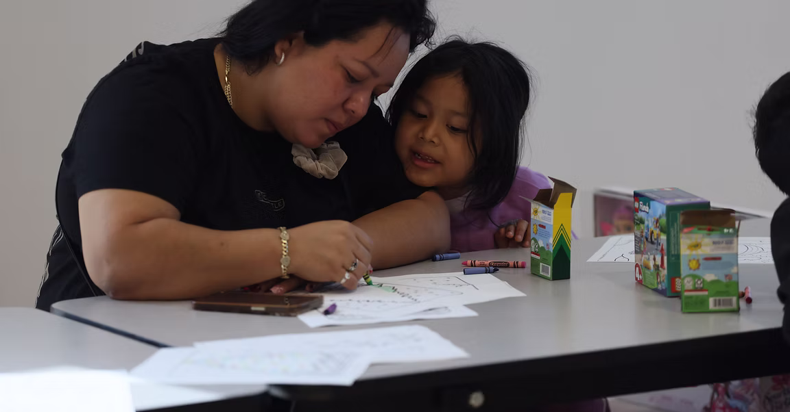 A ROOTED volunteer helping a child learn through play
