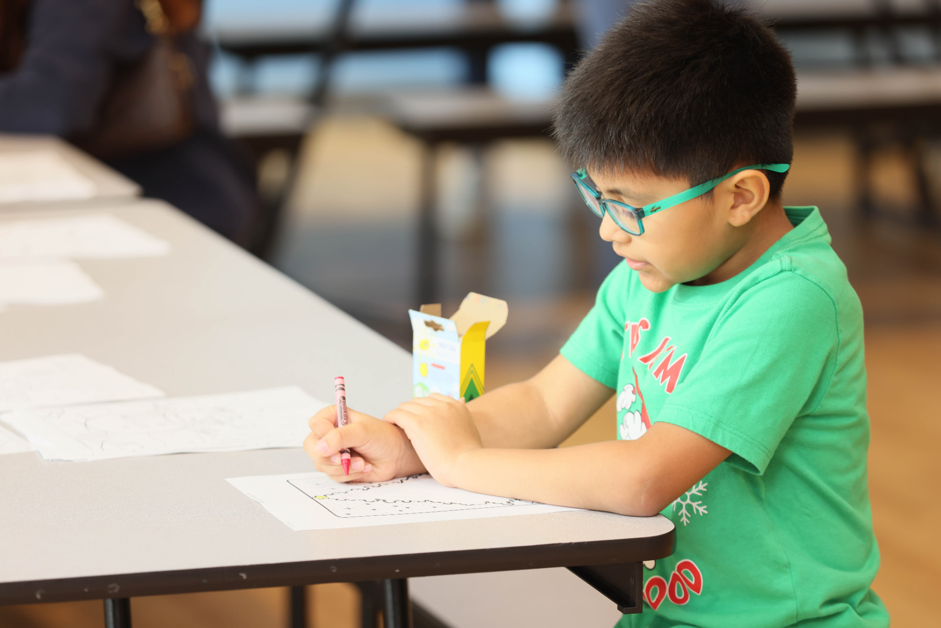 Young student completing an activity at a ROOTED event